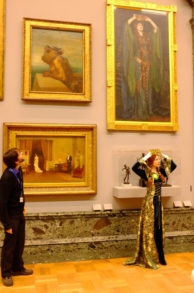 The "tour guide" gathers a crowd and introduces the painting