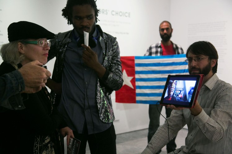 Visitors at the NPG watch a film by West Papuan activist Raki Ap about BP's activities. Photo by Kristian Buus